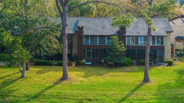 an aerial view of a house with yard swimming pool and outdoor seating