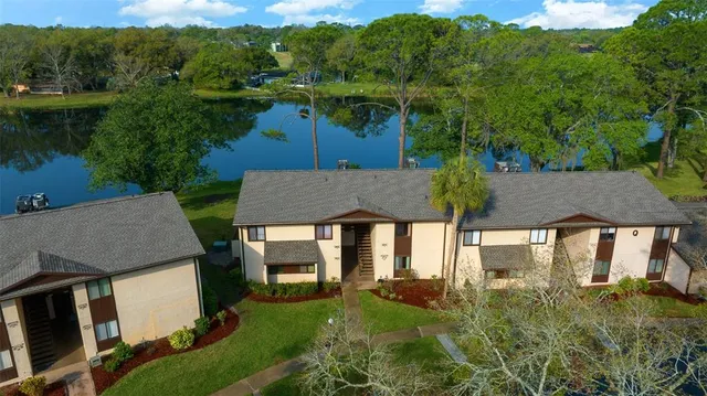 an aerial view of a house with garden space and swimming pool