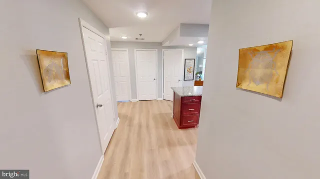a view of a hallway with wooden floor and entryway