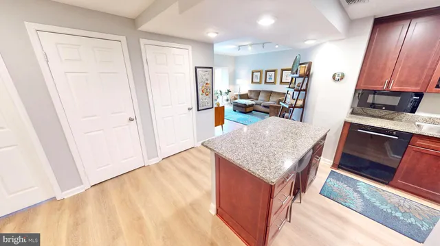 a swimming pool with outdoor seating and barbeque oven