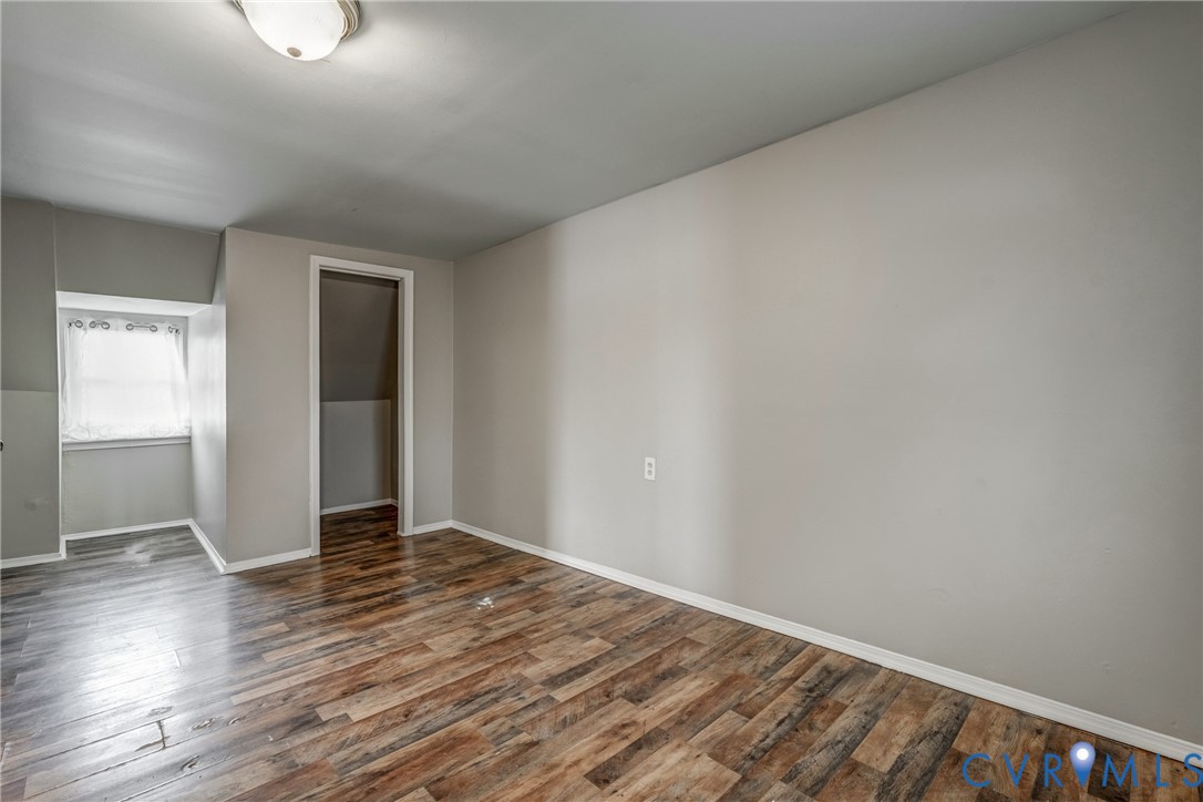 1411 Hopkins Road Richmond, VA 23224 - Photo 11 of 13 a view of an empty room with wooden floor and a window