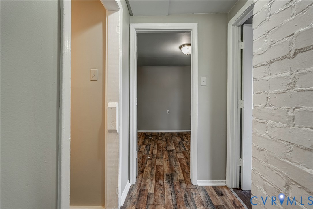 1411 Hopkins Road Richmond, VA 23224 - Photo 12 of 13 a view of a hallway with wooden floor and a bathroom