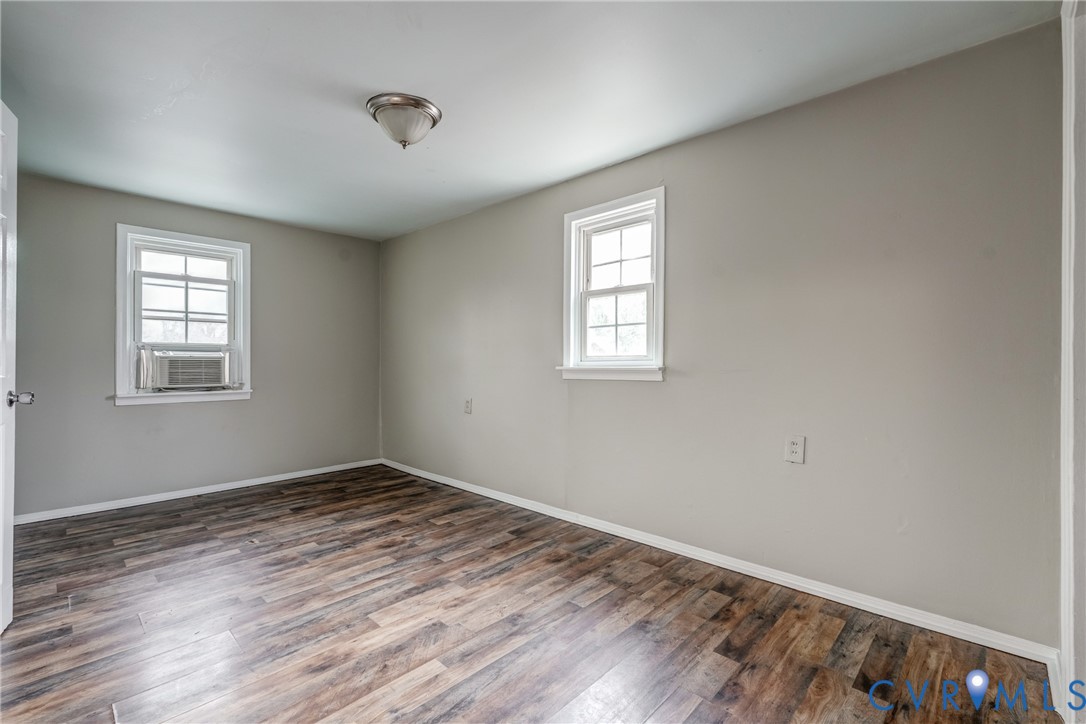 1411 Hopkins Road Richmond, VA 23224 - Photo 13 of 13 a view of an empty room with wooden floor and a window