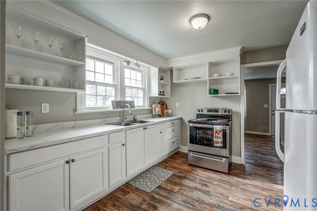 1411 Hopkins Road Richmond, VA 23224 - Photo 5 of 13 a kitchen with a sink cabinets stainless steel appliances and window