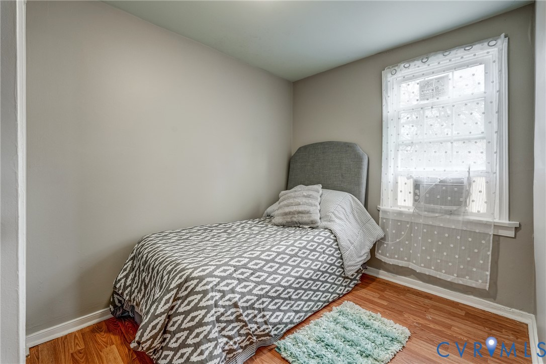 1411 Hopkins Road Richmond, VA 23224 - Photo 9 of 13 a bedroom with a bed and wooden floor