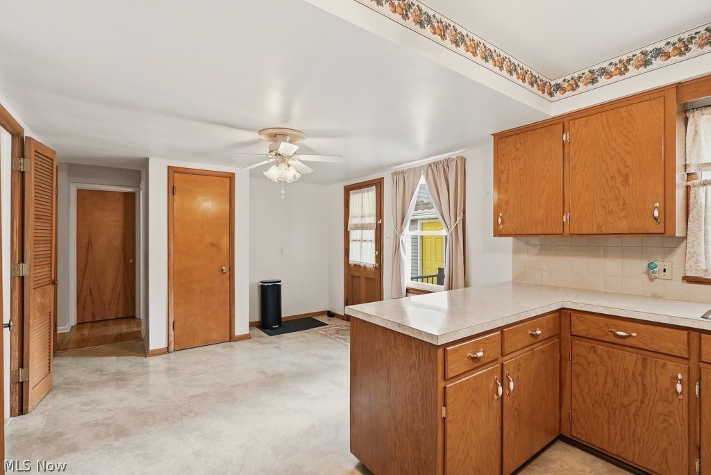 161 Pinehurst Road Munroe Falls, OH 44262 - Photo 15 of 40 Kitchen featuring wood-finish cabinetry, light-toned countertops, and a tiled backsplash