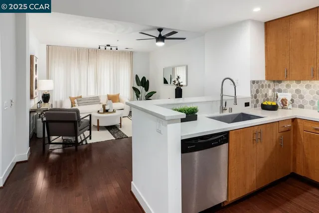 a kitchen with a sink cabinets and wooden floor