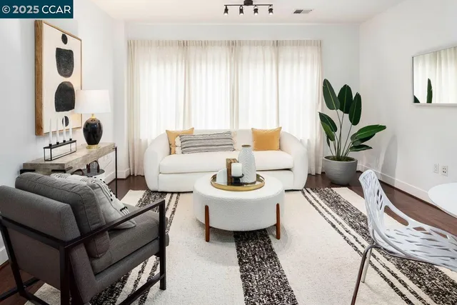 a living room with furniture flowerpot and window