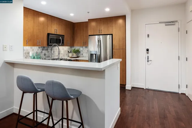 a kitchen with stainless steel appliances a refrigerator and microwave