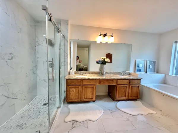 a spacious bathroom with a granite countertop tub sink and a mirror