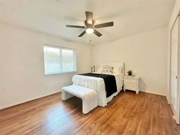 a bedroom with a bed lamp closet and window
