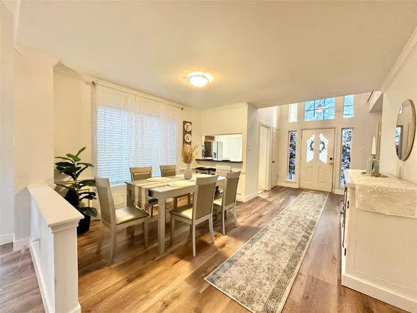 a living room with furniture a dining table and chairs with kitchen view