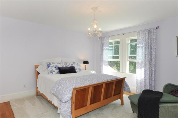130 Koning Farm Road Carlisle, MA 01741 - Photo 8 of 21 a bedroom with a bed chandelier and a window