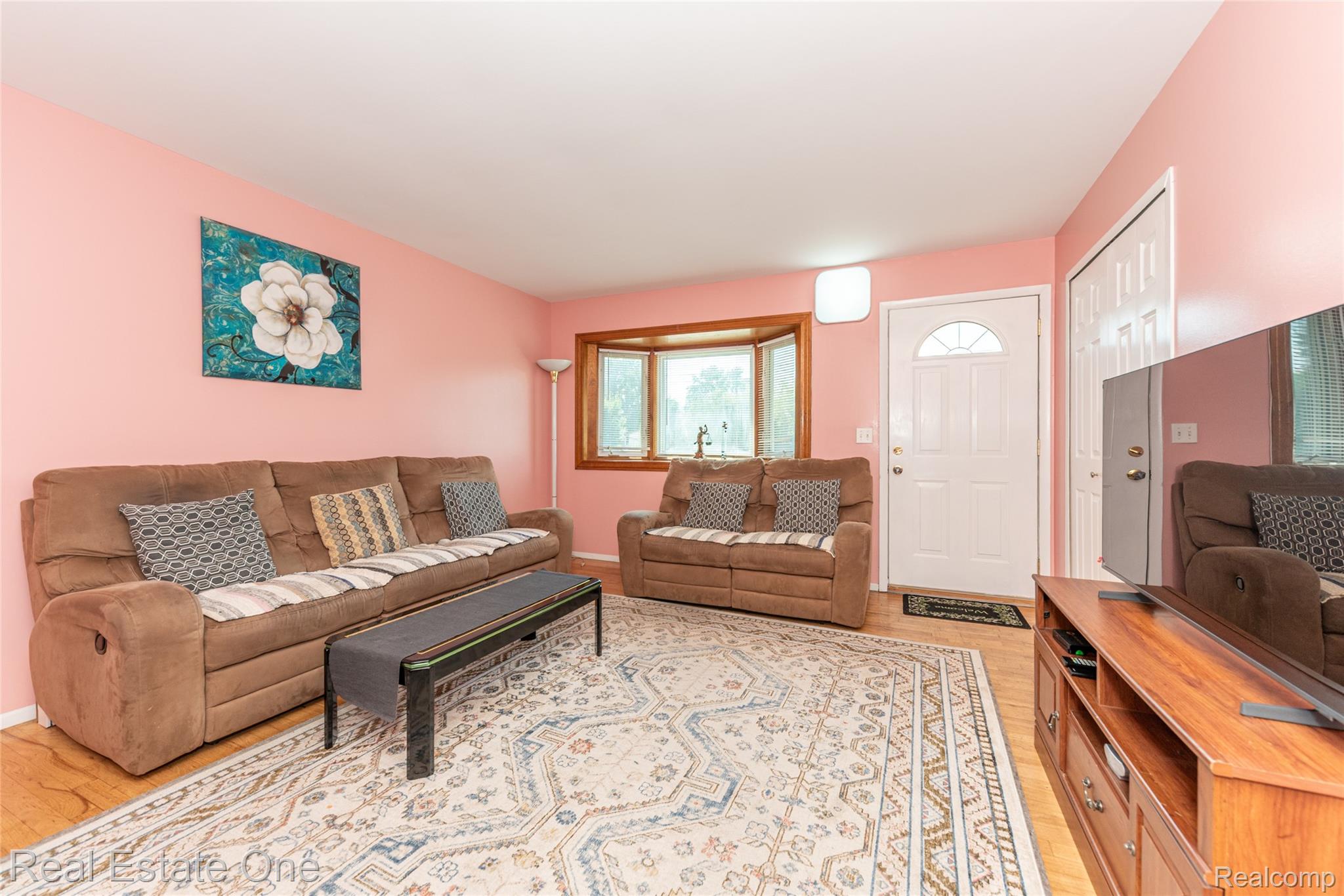 1380 North Sheldon Road Canton, MI 48187 - Photo 11 of 29 Living area featuring light wood-finish flooring and a central area rug