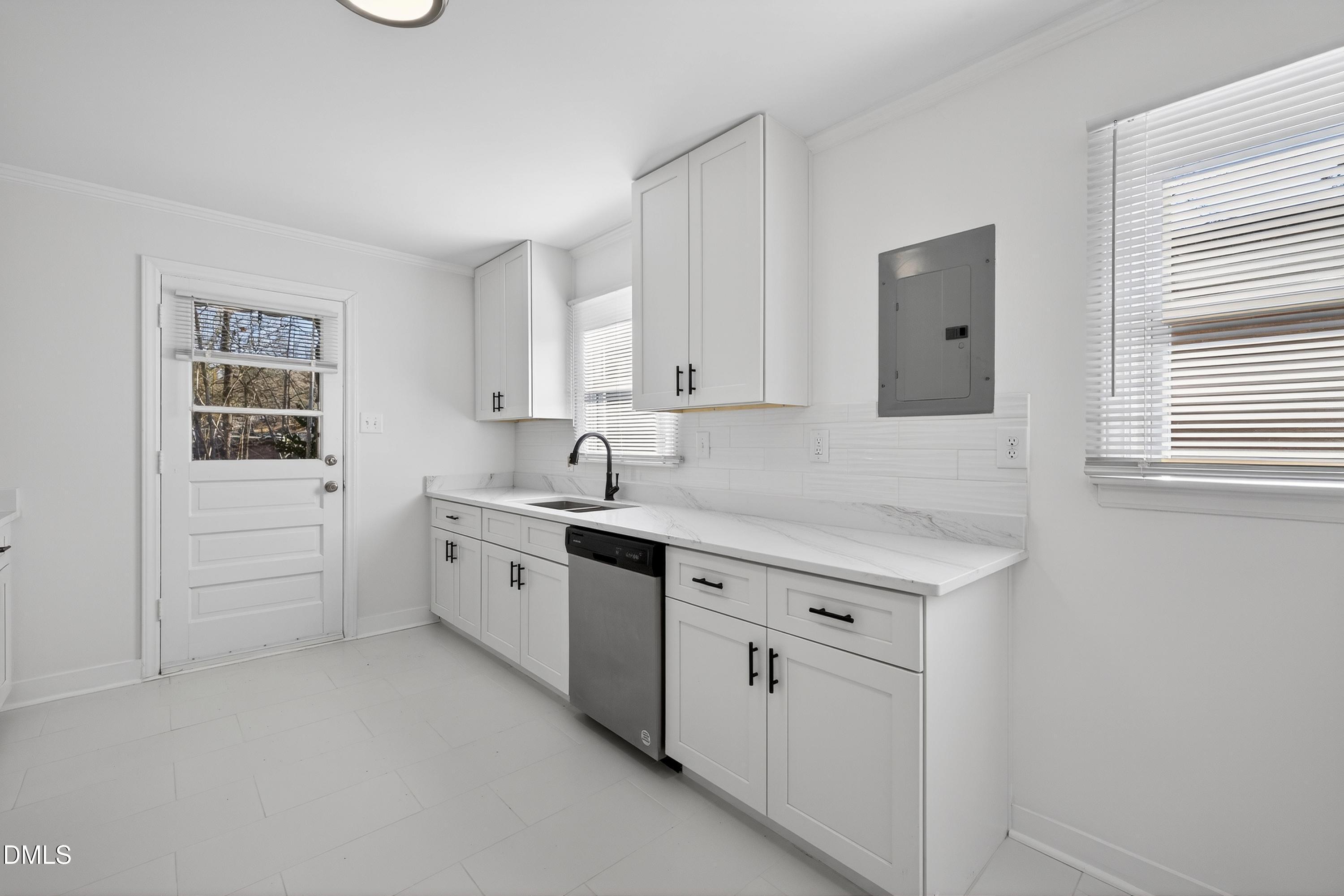 302 Normandy Street Durham, NC 27707 - Photo 12 of 29 a kitchen with white cabinets and white appliances