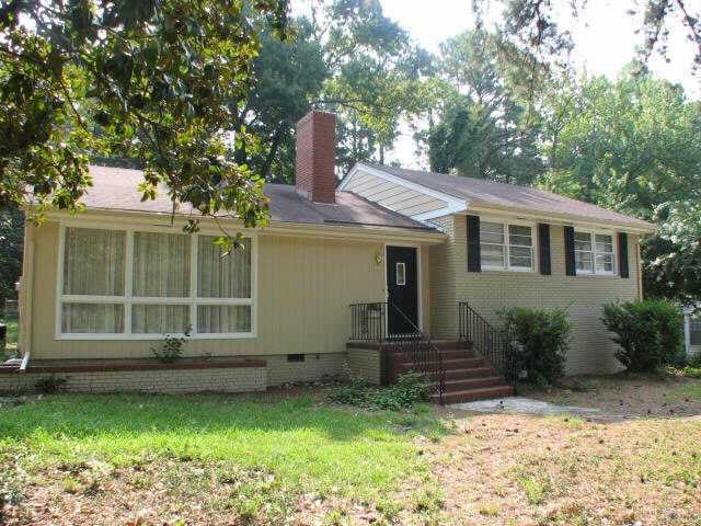 810 Faircloth Street Raleigh, NC 27607 - Photo 1 of 10 a front view of a house with a garden and yard