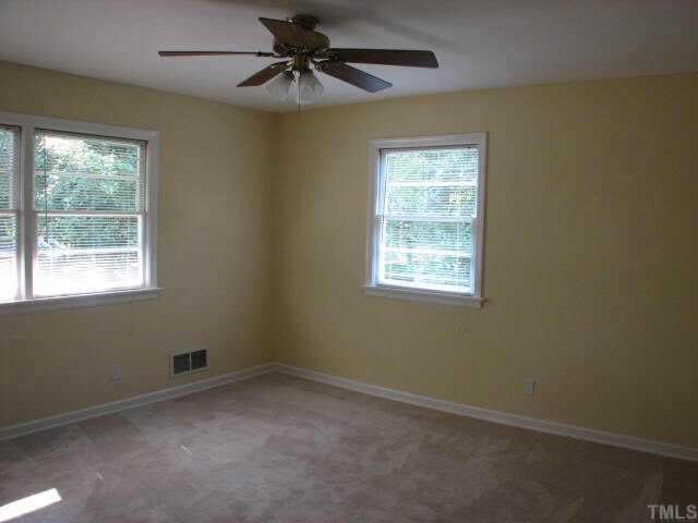 810 Faircloth Street Raleigh, NC 27607 - Photo 7 of 10 an empty room with a window and a fan