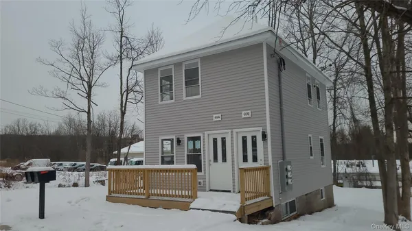a view of backyard with a table and chairs and potted plants