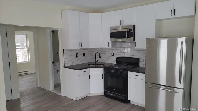 a kitchen with stainless steel appliances a refrigerator stove and sink
