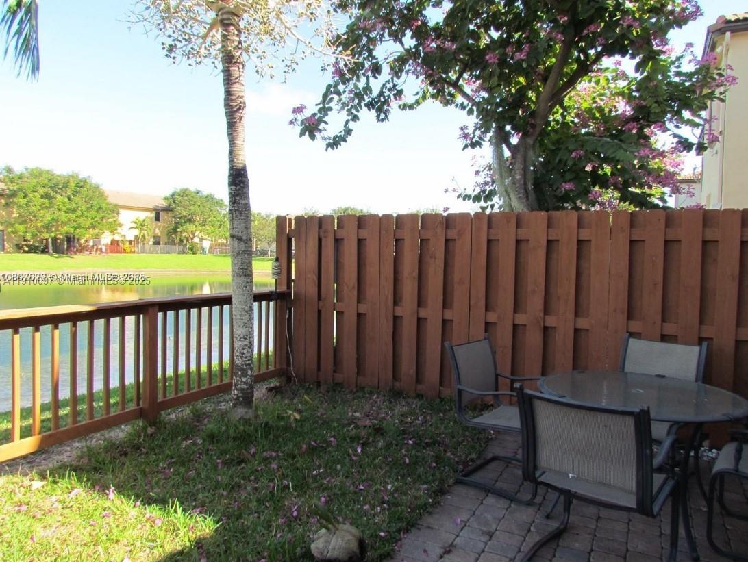 11343 Southwest 239 Street, Unit 11343 Homestead, FL 33032 - Photo 4 of 12 a view of a backyard with a large trees