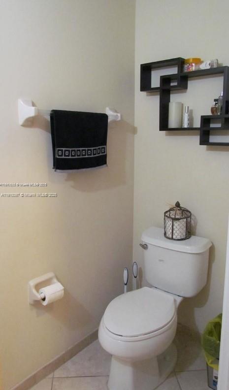 11343 Southwest 239 Street, Unit 11343 Homestead, FL 33032 - Photo 9 of 12 a bathroom with a toilet a sink and a mirror