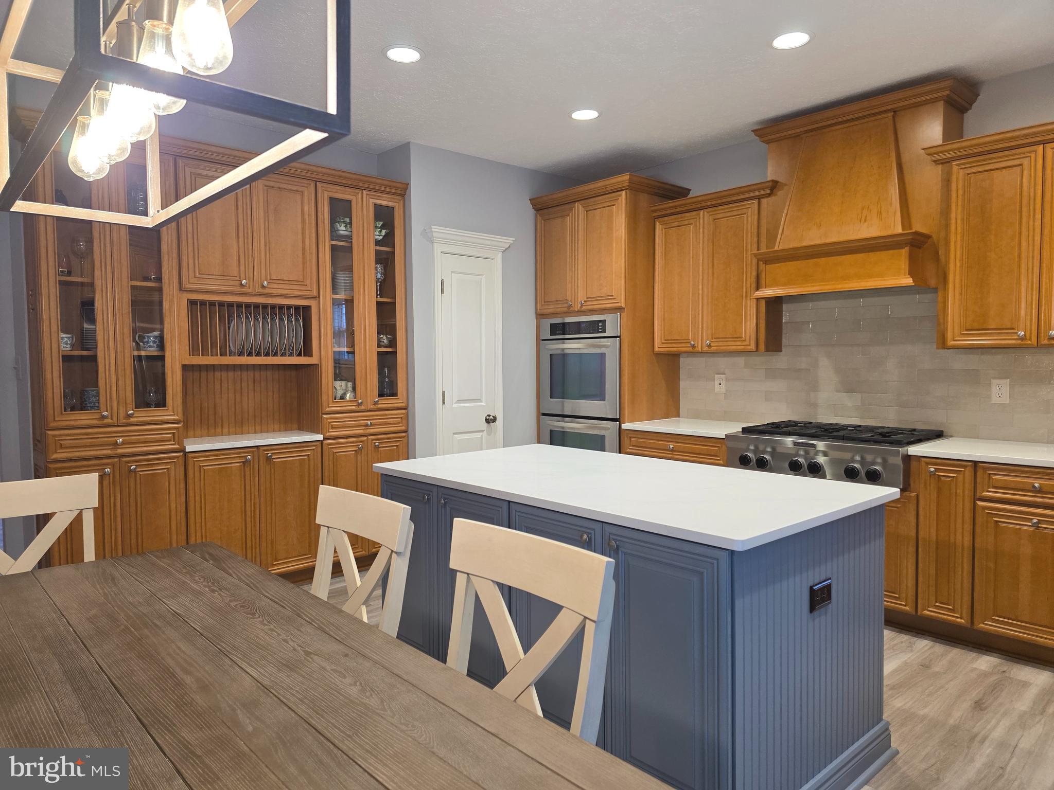 2441 Kemper Road Crofton, MD 21114 - Photo 18 of 63 a kitchen that has a sink a stove and wooden floor