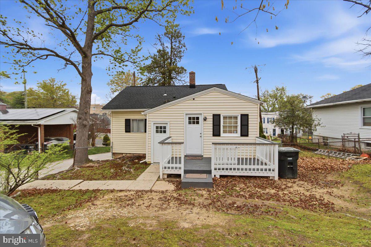 4705 Eads Street Northeast Washington, DC 20019 - Photo 14 of 16 a white house that has a small yard and large trees