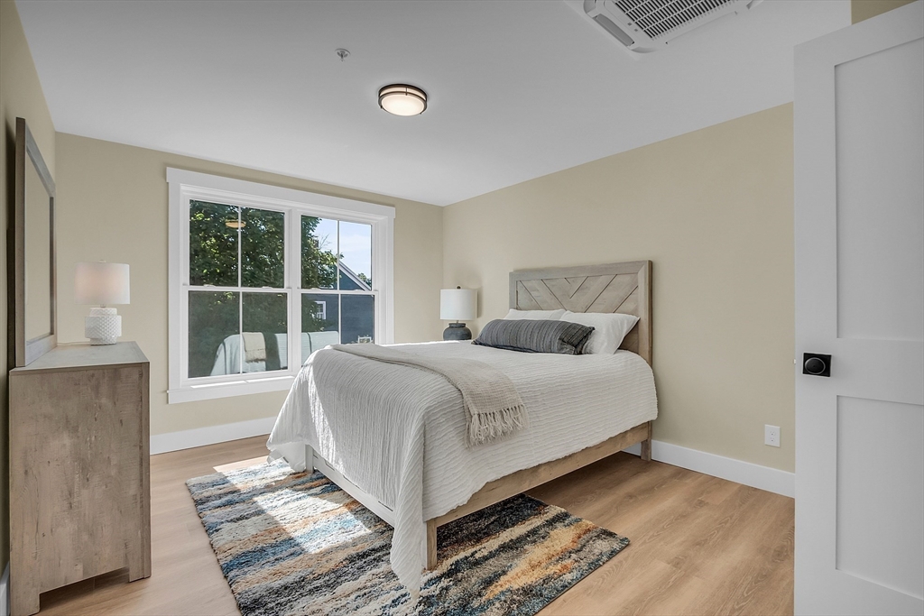 50 Main Street, Unit 101 Pepperell, MA 01463 - Photo 11 of 20 a bedroom with a bed and a window