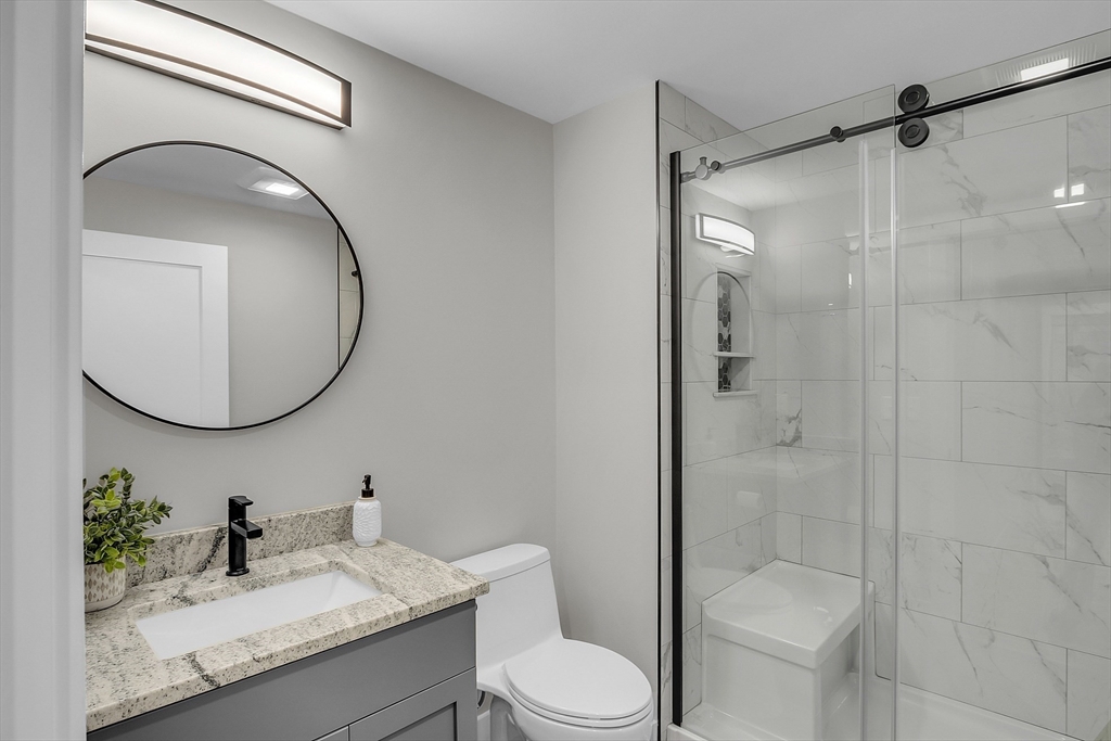 50 Main Street, Unit 101 Pepperell, MA 01463 - Photo 13 of 20 a bathroom with a sink toilet and shower