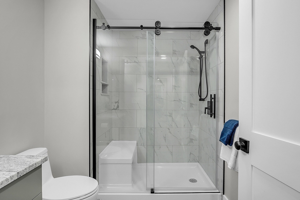 50 Main Street, Unit 101 Pepperell, MA 01463 - Photo 14 of 20 a bathroom with a shower toilet and sink