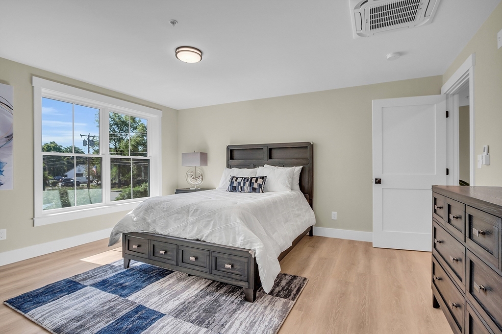 50 Main Street, Unit 101 Pepperell, MA 01463 - Photo 15 of 20 a large bed sitting in a bedroom next to a window
