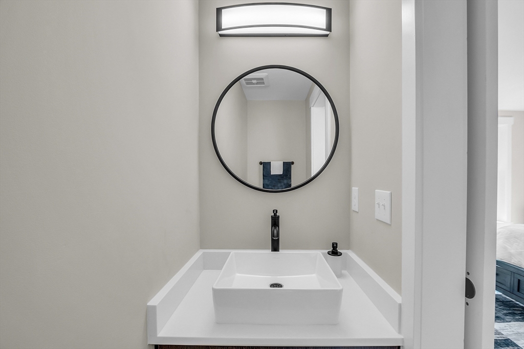 50 Main Street, Unit 101 Pepperell, MA 01463 - Photo 16 of 20 a bathroom with a sink and a mirror