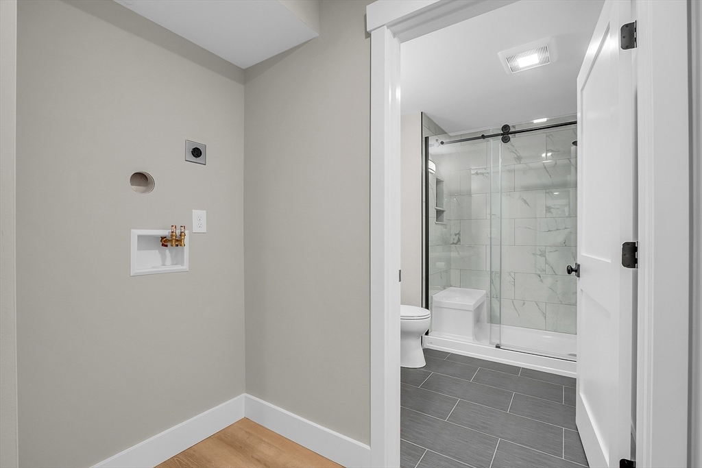 50 Main Street, Unit 101 Pepperell, MA 01463 - Photo 17 of 20 a bathroom with a shower and a toilet
