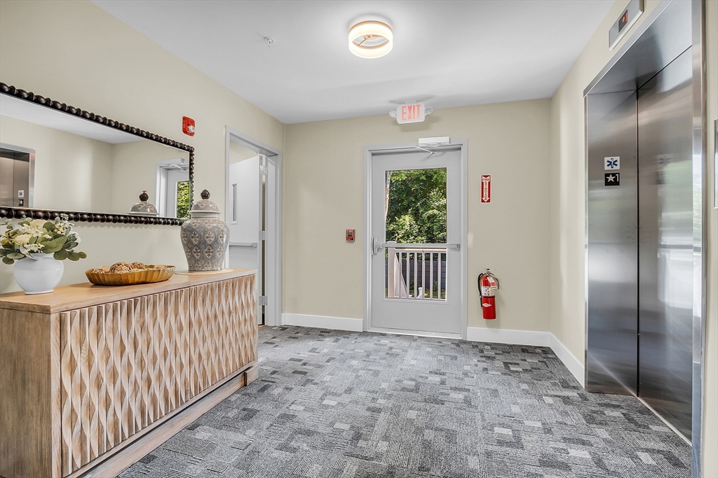 50 Main Street, Unit 101 Pepperell, MA 01463 - Photo 2 of 20 a view of an empty room with window and wooden floor