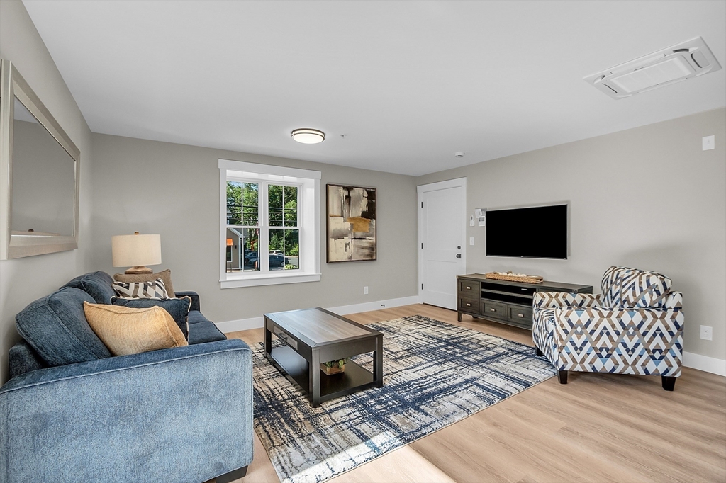 50 Main Street, Unit 101 Pepperell, MA 01463 - Photo 10 of 20 a living room with furniture and a flat screen tv