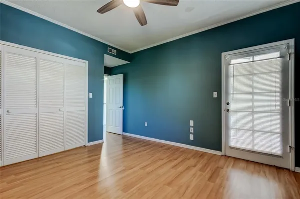 an empty room with wooden floor and closet