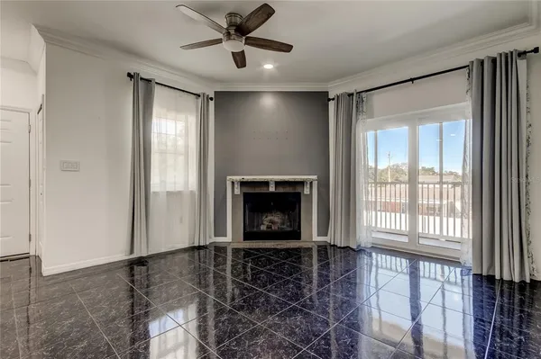 a view of a livingroom with a ceiling fan and window