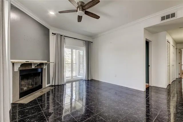 a living room with furniture a fireplace and a window