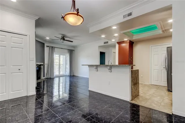 a view of a kitchen center island and stainless steel appliances