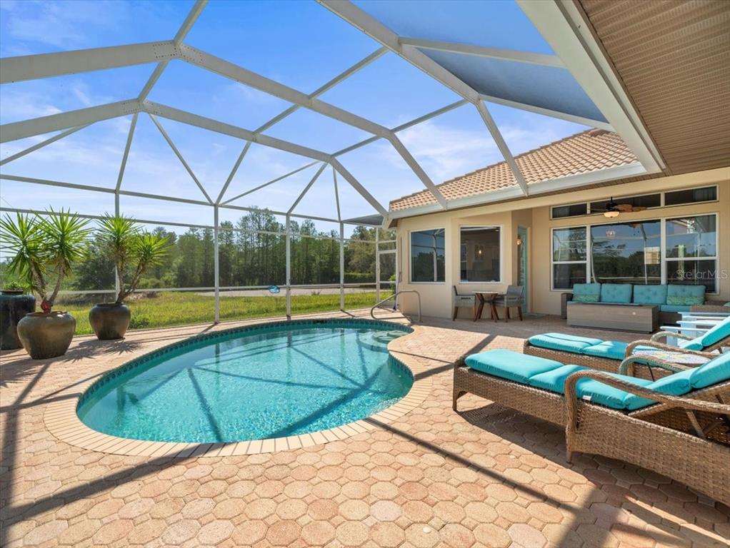 a view of a patio with swimming pool table and chairs