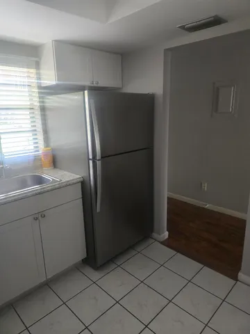 a kitchen with a refrigerator and a sink