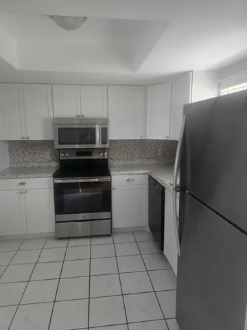 a kitchen with a stove a refrigerator and a sink