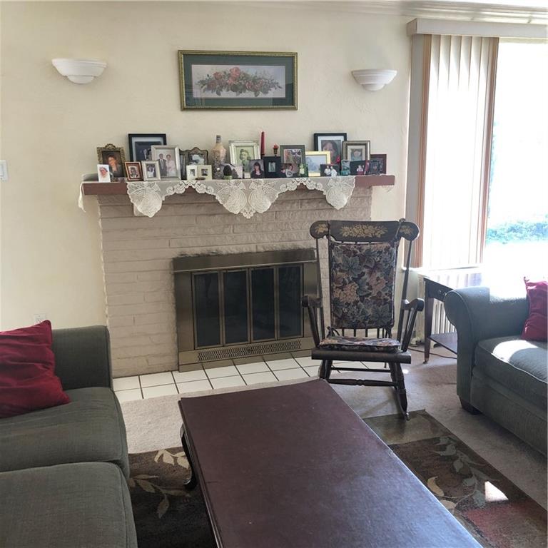 300 Radisson Road Pittsburgh, PA 15227 - Photo 3 of 31 a living room with furniture and a fireplace
