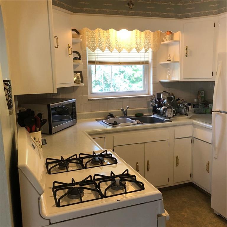 300 Radisson Road Pittsburgh, PA 15227 - Photo 5 of 31 a kitchen with a stove a sink and a window