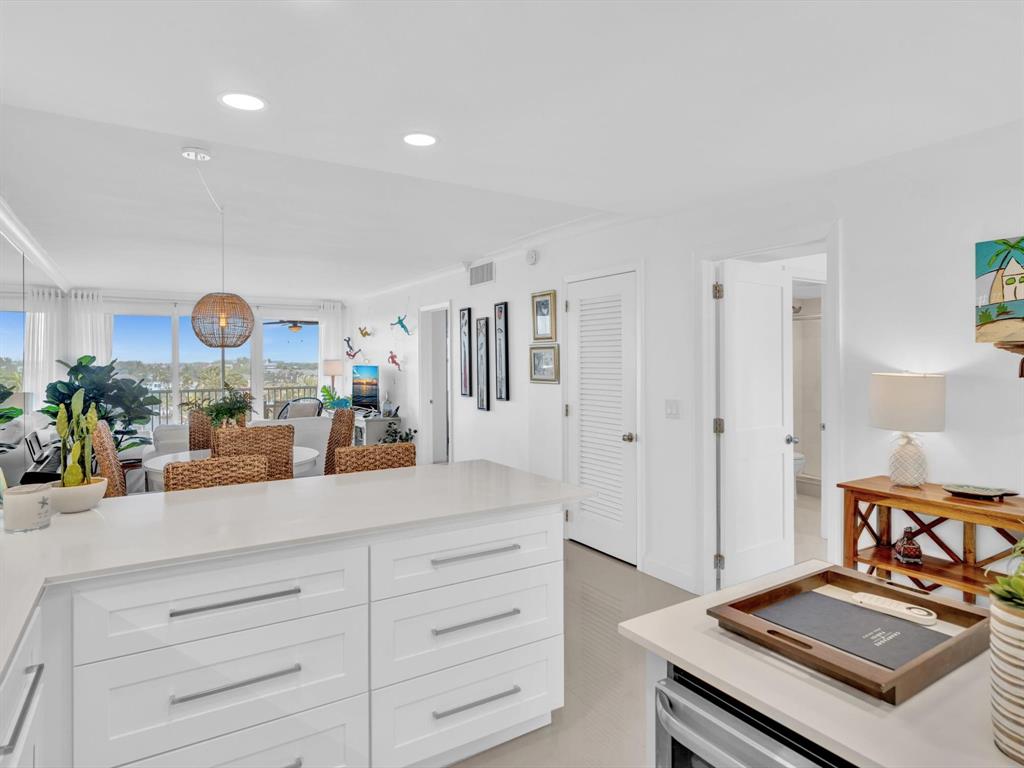 3100 South Ocean Boulevard, Unit 712 Highland Beach, FL 33487 - Photo 11 of 50 a kitchen with stainless steel appliances granite countertop a stove and a sink