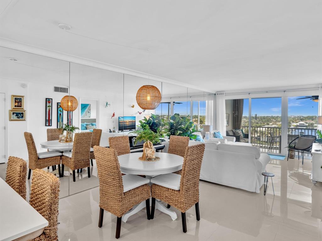 3100 South Ocean Boulevard, Unit 712 Highland Beach, FL 33487 - Photo 12 of 50 a view of a dining room and livingroom with furniture wooden floor and a rug