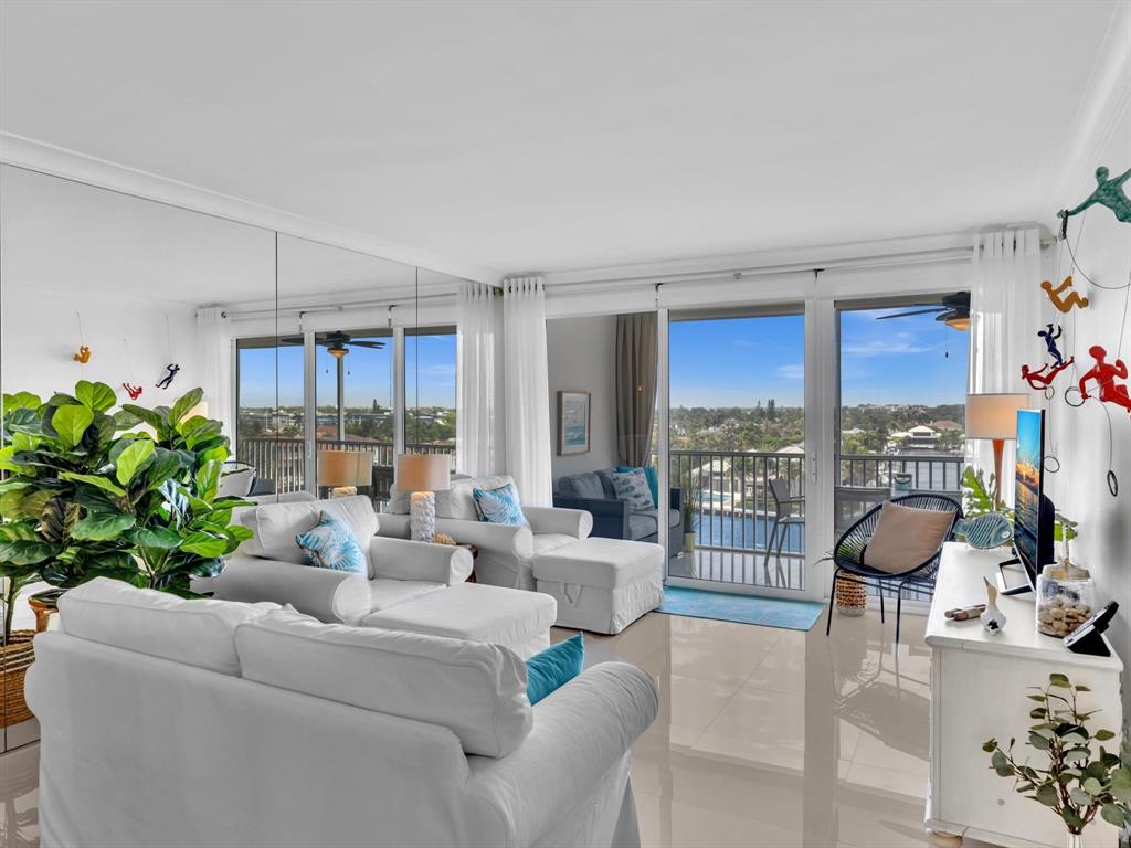 3100 South Ocean Boulevard, Unit 712 Highland Beach, FL 33487 - Photo 13 of 50 a living room with furniture a chandelier and a floor to ceiling window