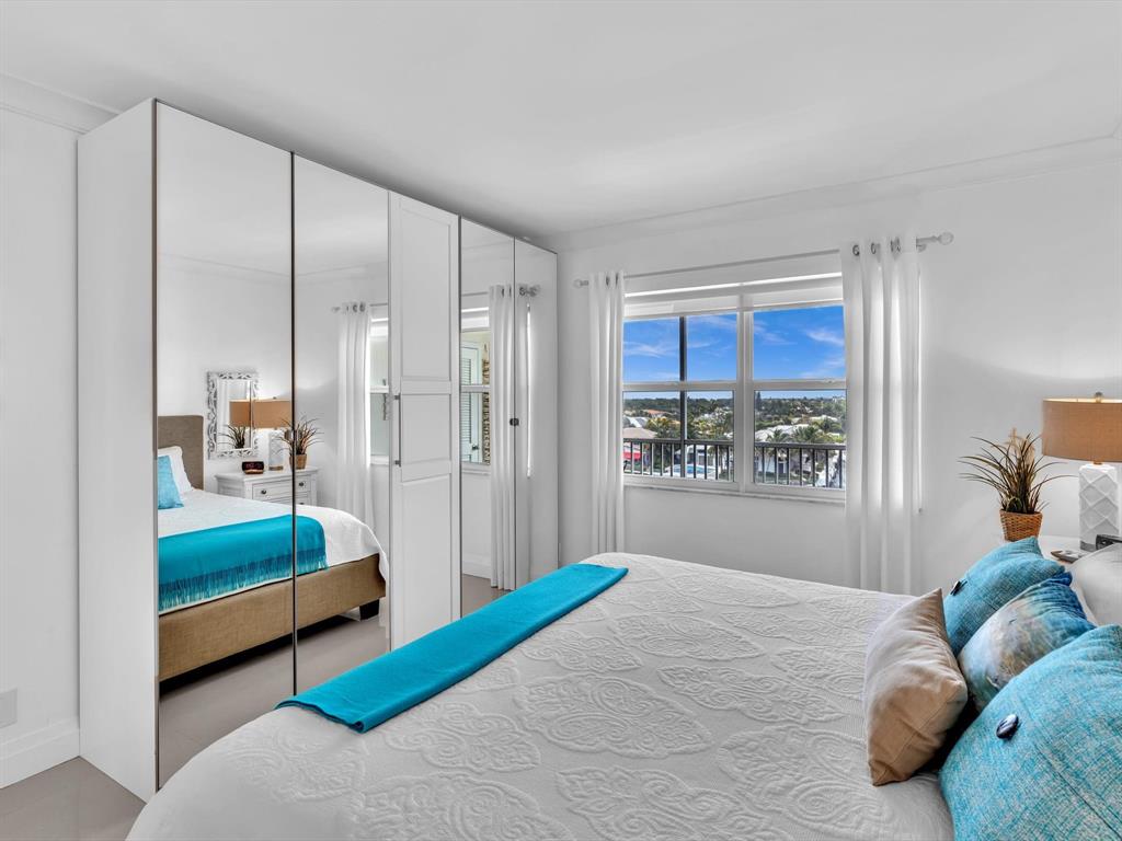 3100 South Ocean Boulevard, Unit 712 Highland Beach, FL 33487 - Photo 18 of 50 a bedroom with a bed and a large window
