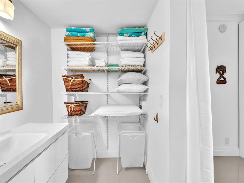 3100 South Ocean Boulevard, Unit 712 Highland Beach, FL 33487 - Photo 23 of 50 a storage room with washer and dryer