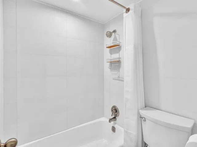 a bathroom with a bathtub and toilet